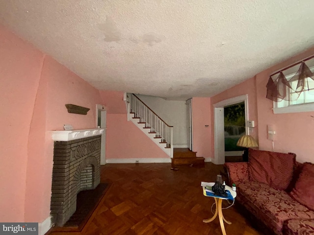 5122 Stenton Ave, Philadelphia, PA 19144 - unfurnished living room featuring a textured ceiling, stairway, and a fireplace