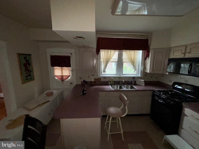 5122 Stenton Ave, Philadelphia, PA 19144 - kitchen featuring black appliances, white cabinets, and a peninsula