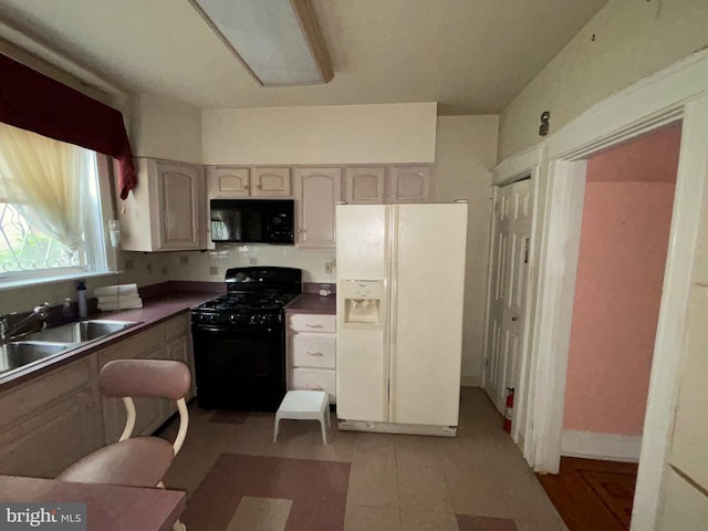 5122 Stenton Ave, Philadelphia, PA 19144 - kitchen featuring black appliances, decorative backsplash, dark countertops, and light floors