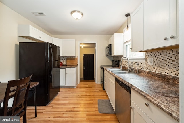 104 N Beech Ave, Highland Springs, VA 23075 - kitchen featuring black appliances, light wood-style floors, tasteful backsplash, and white cabinetry