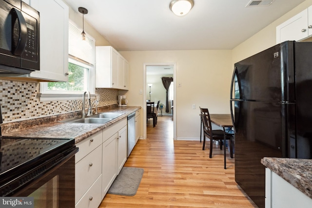 104 N Beech Ave, Highland Springs, VA 23075 - kitchen featuring black appliances, light wood-style floors, white cabinets, and tasteful backsplash