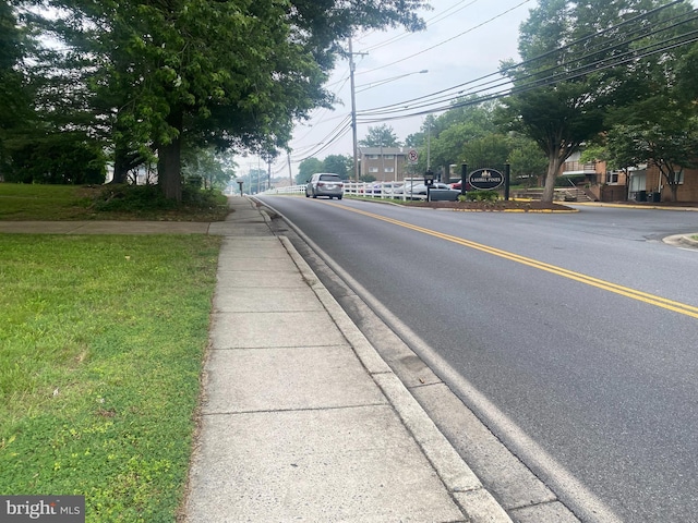 14604 Bowie Rd, Laurel, MD 20708 - view of asphalt road featuring sidewalks, curbs, street lighting, and traffic signs