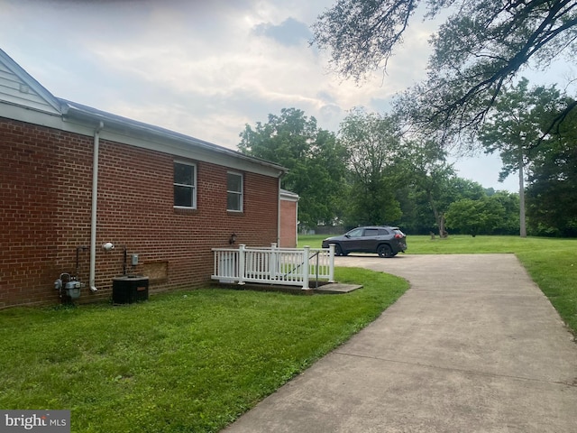 14604 Bowie Rd, Laurel, MD 20708 - view of side of property featuring a yard, concrete driveway, and brick siding