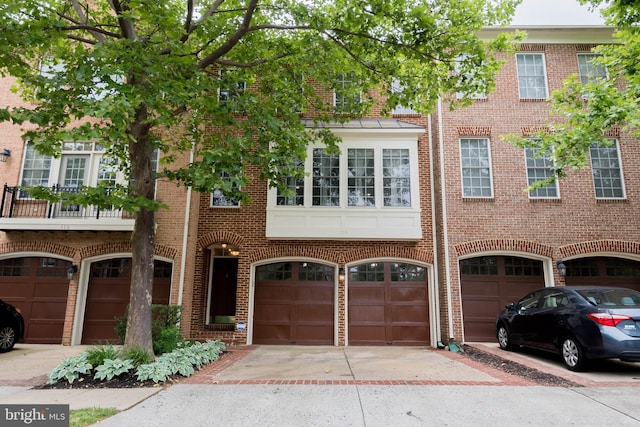 114 Herndon Mill Cir, Herndon, VA 20170 - townhome / multi-family property with a garage, brick siding, and driveway