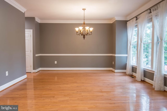 114 Herndon Mill Cir, Herndon, VA 20170 - spare room with a chandelier, light wood-style flooring, and crown molding