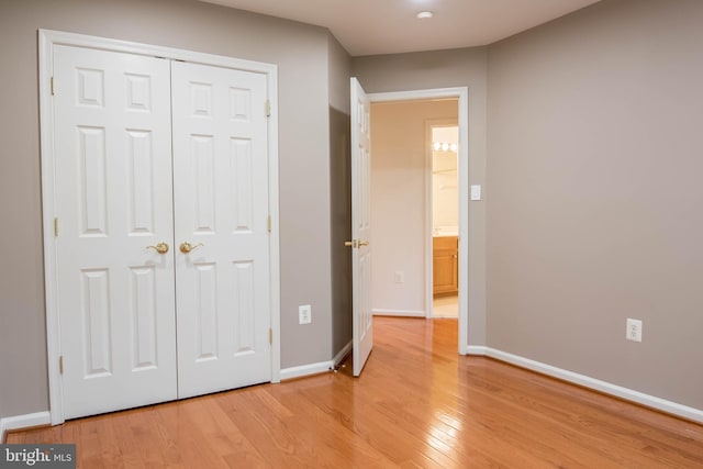 114 Herndon Mill Cir, Herndon, VA 20170 - unfurnished bedroom featuring light wood-style flooring and a closet