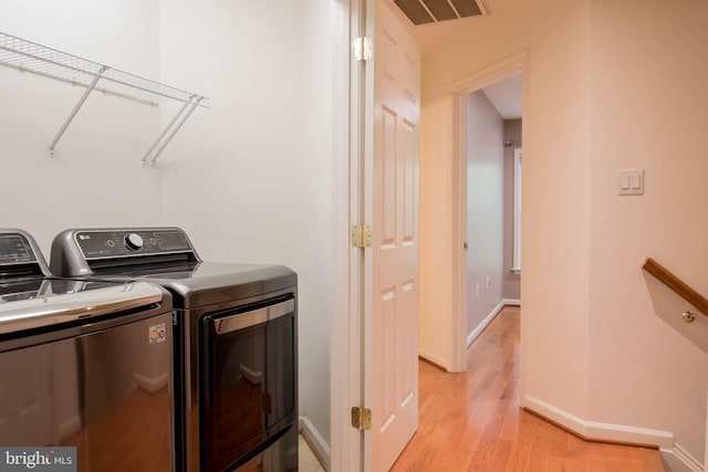 114 Herndon Mill Cir, Herndon, VA 20170 - washroom with washer and dryer and light wood-style floors