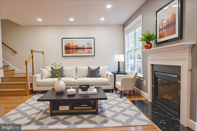 114 Herndon Mill Cir, Herndon, VA 20170 - living room with wood finished floors, stairway, recessed lighting, and a fireplace with flush hearth