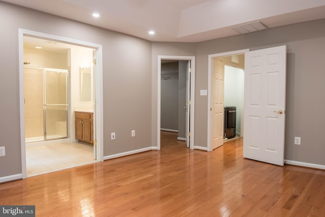 114 Herndon Mill Cir, Herndon, VA 20170 - unfurnished bedroom featuring light wood-style floors, a spacious closet, recessed lighting, ensuite bath, and a closet