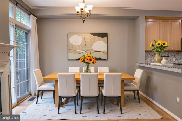 114 Herndon Mill Cir, Herndon, VA 20170 - dining room with a chandelier and light wood-style flooring