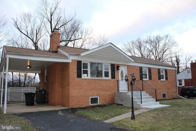 7107 Loch Raven Rd, Temple Hills, MD 20748 - single story home with brick siding, driveway, an attached carport, a chimney, and a front yard