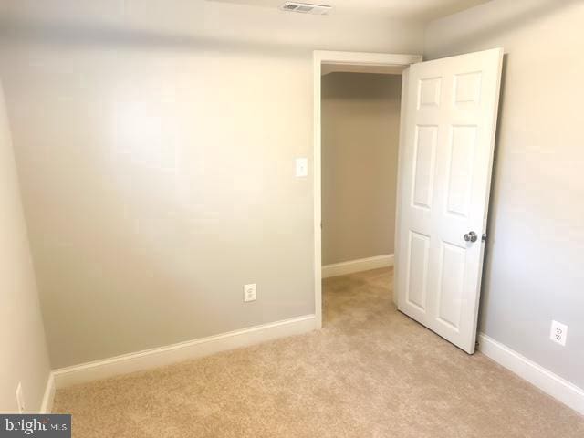 7107 Loch Raven Rd, Temple Hills, MD 20748 - unfurnished room with light colored carpet and baseboards