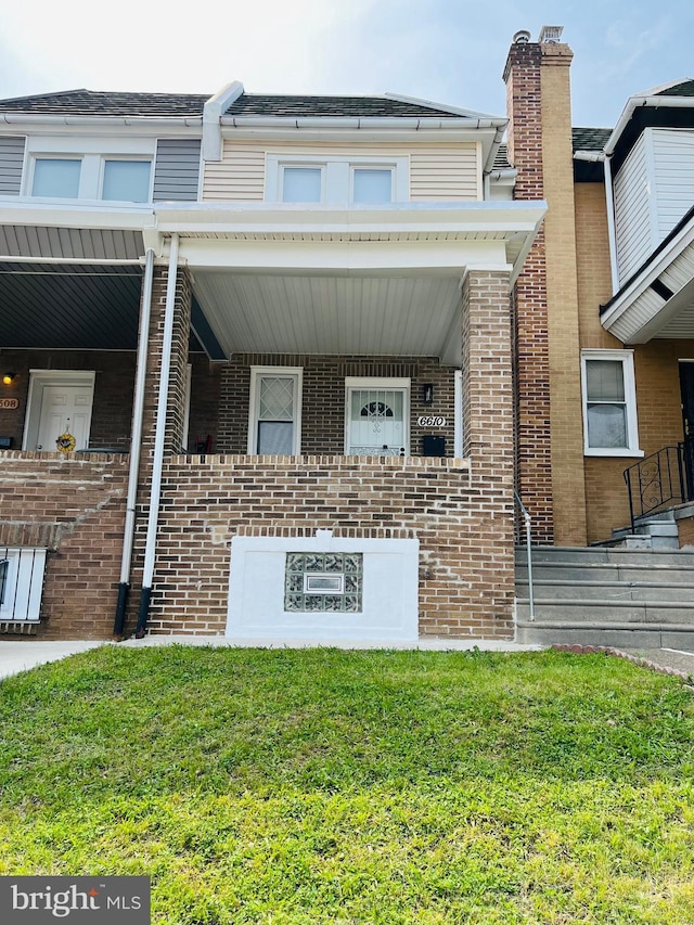6610 N Smedley St, Philadelphia, PA 19126 - view of front of house featuring brick siding, a porch, a front yard, and a chimney