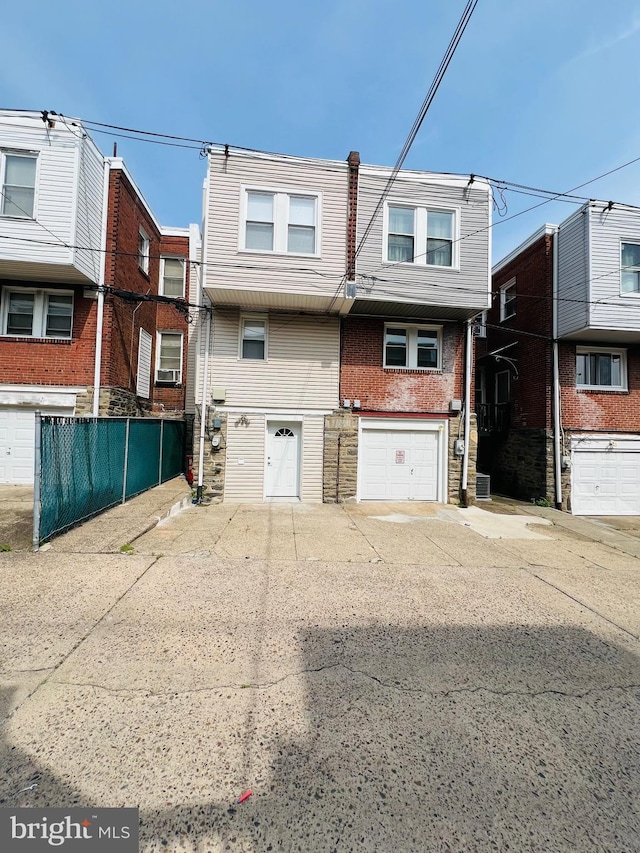 6610 N Smedley St, Philadelphia, PA 19126 - view of front of property with a garage, driveway, and stone siding