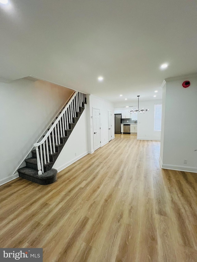6610 N Smedley St, Philadelphia, PA 19126 - unfurnished living room featuring stairs, a chandelier, light wood-style flooring, recessed lighting, and ornamental molding