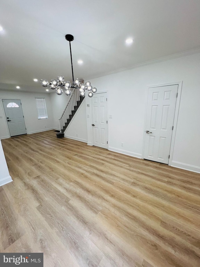 6610 N Smedley St, Philadelphia, PA 19126 - unfurnished living room featuring light wood-type flooring, a chandelier, recessed lighting, crown molding, and stairway
