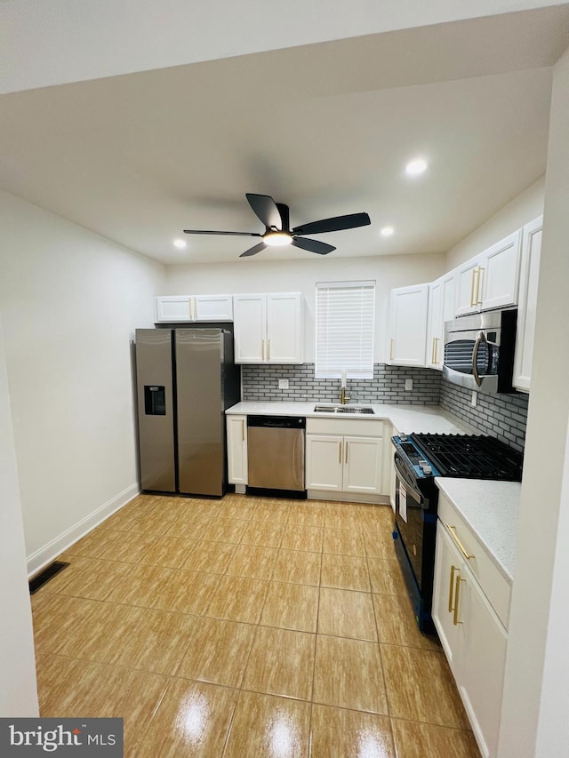 6610 N Smedley St, Philadelphia, PA 19126 - kitchen with appliances with stainless steel finishes, tasteful backsplash, light countertops, a ceiling fan, and white cabinetry