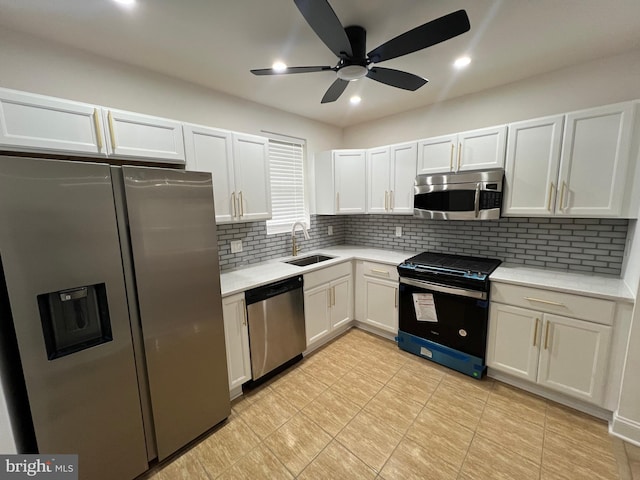 6610 N Smedley St, Philadelphia, PA 19126 - kitchen featuring appliances with stainless steel finishes, light countertops, a ceiling fan, backsplash, and white cabinetry