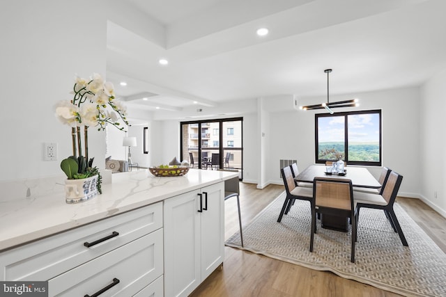 205 Yoakum Pkwy Unit 1712, Alexandria, VA 22304 - kitchen featuring white cabinets, healthy amount of natural light, light wood-type flooring, and recessed lighting