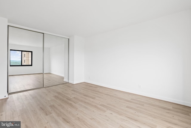 205 Yoakum Pkwy Unit 1712, Alexandria, VA 22304 - unfurnished bedroom featuring wood finished floors and a closet