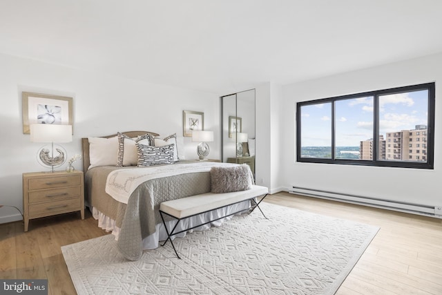 205 Yoakum Pkwy Unit 1712, Alexandria, VA 22304 - bedroom with baseboard heating and light wood-type flooring