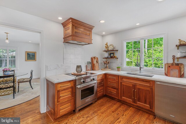 4704 Sweetbriar Cir, Emmaus, PA 18049 - kitchen featuring stainless steel appliances, custom exhaust hood, light countertops, tasteful backsplash, and light wood-style floors