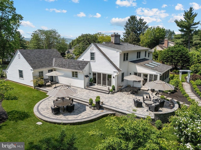 4704 Sweetbriar Cir, Emmaus, PA 18049 - rear view of property featuring a sunroom, a patio area, a chimney, and an outdoor living space with a fire pit