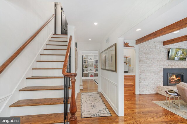 4704 Sweetbriar Cir, Emmaus, PA 18049 - staircase featuring wood finished floors, recessed lighting, built in shelves, and a stone fireplace