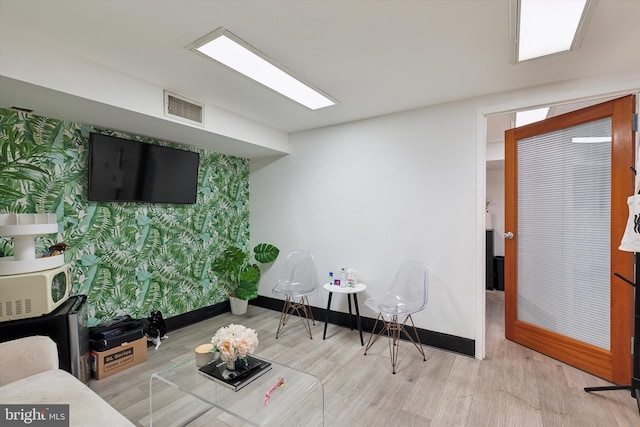 119 S Easton Rd, Glenside, PA 19038 - living area with wallpapered walls, wood finished floors, and an accent wall