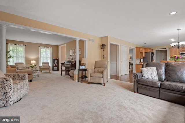 1817 Old Farm Ln, Lancaster, PA 17602 - living area featuring decorative columns, light carpet, recessed lighting, and a chandelier
