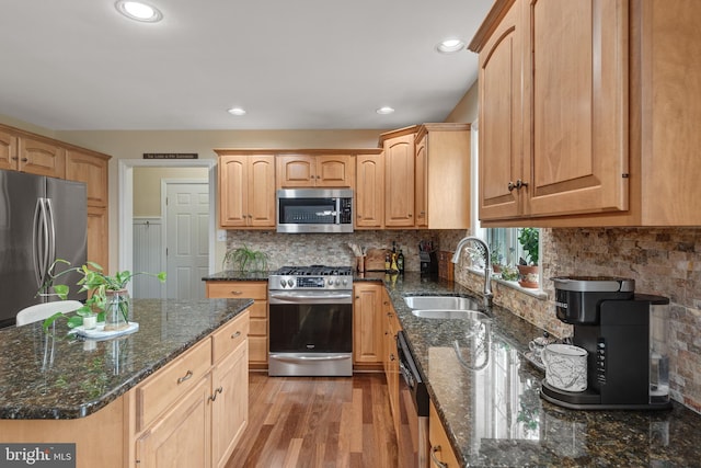 1817 Old Farm Ln, Lancaster, PA 17602 - kitchen with stainless steel appliances, light wood-style floors, dark stone counters, decorative backsplash, and recessed lighting