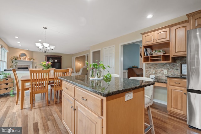1817 Old Farm Ln, Lancaster, PA 17602 - kitchen with light brown cabinetry, freestanding refrigerator, light wood finished floors, open shelves, and tasteful backsplash