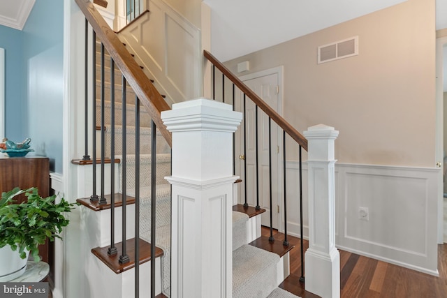1817 Old Farm Ln, Lancaster, PA 17602 - staircase featuring wood finished floors, a wainscoted wall, and a decorative wall