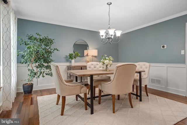 1817 Old Farm Ln, Lancaster, PA 17602 - dining area featuring a chandelier, wood finished floors, crown molding, and wainscoting