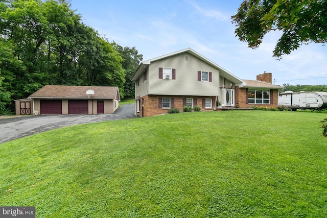 848 Rapp Rd, Howard, PA 16841 - split level home featuring a detached garage, an outbuilding, a chimney, and brick siding