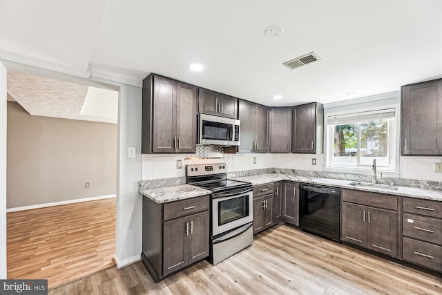 12 Bantry Ct, Waldorf, MD 20602 - kitchen with appliances with stainless steel finishes, dark brown cabinets, light wood finished floors, light stone countertops, and recessed lighting