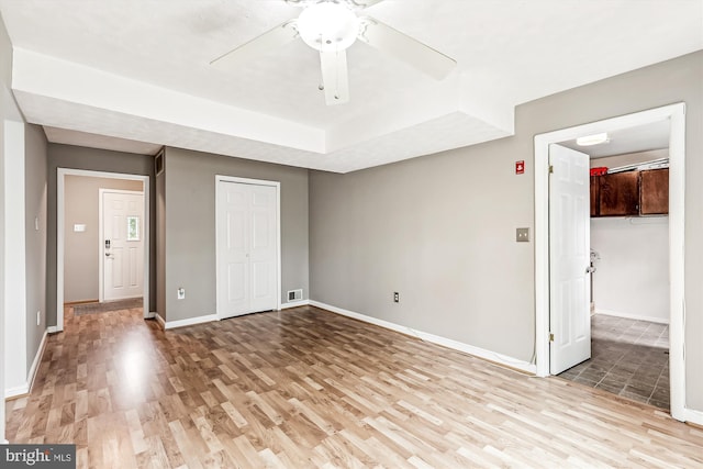 12 Bantry Ct, Waldorf, MD 20602 - unfurnished bedroom featuring a closet, light wood-style floors, a ceiling fan, and a tray ceiling