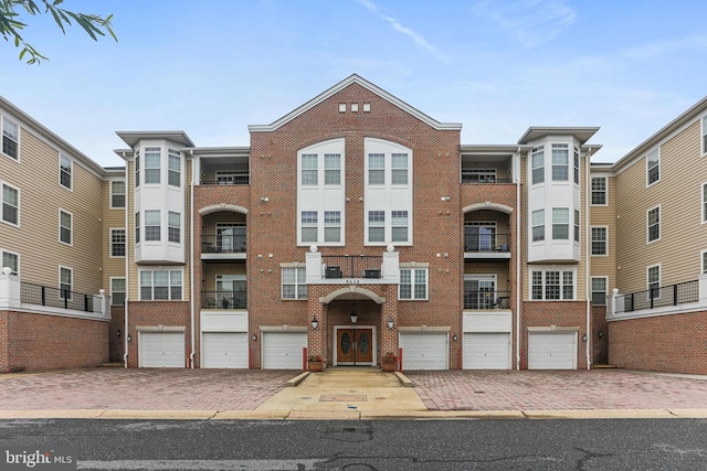 8608 Fluttering Leaf Trl Unit 208, Odenton, MD 21113 - view of building exterior with an attached garage and driveway