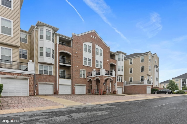 8608 Fluttering Leaf Trl Unit 208, Odenton, MD 21113 - view of property featuring a garage and driveway