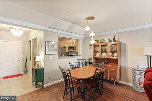 8608 Fluttering Leaf Trl Unit 208, Odenton, MD 21113 - dining space with a chandelier, wood finished floors, and ornamental molding