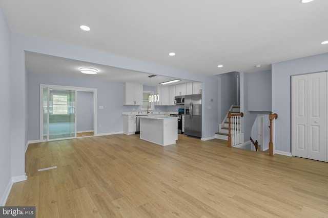 7306 Gavin St, Hyattsville, MD 20784 - unfurnished living room featuring light wood-style flooring, stairs, and recessed lighting