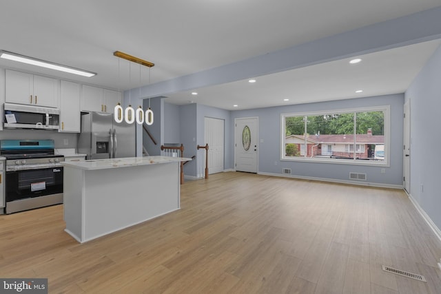 7306 Gavin St, Hyattsville, MD 20784 - kitchen with appliances with stainless steel finishes, light wood-style flooring, decorative light fixtures, recessed lighting, and a center island