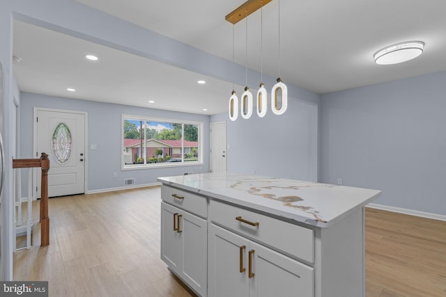 7306 Gavin St, Hyattsville, MD 20784 - kitchen featuring light wood-style floors, hanging light fixtures, a kitchen island, recessed lighting, and light stone countertops