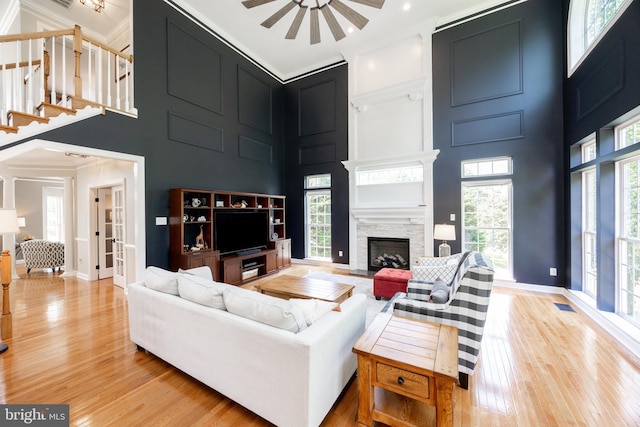 1568 Tattersall, West Chester, PA 19380 - living area featuring a high ceiling, light wood-type flooring, a fireplace, crown molding, and ceiling fan