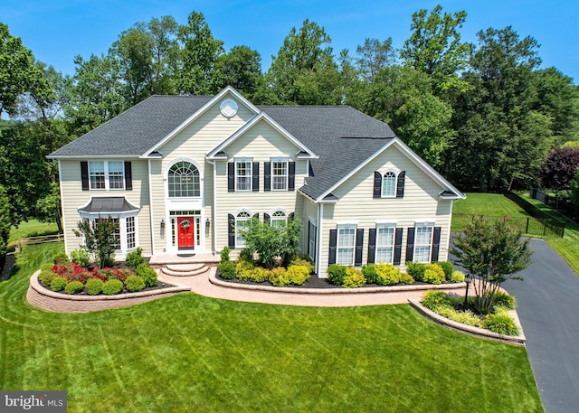 1568 Tattersall, West Chester, PA 19380 - colonial home with a front lawn, roof with shingles, and view of scattered trees