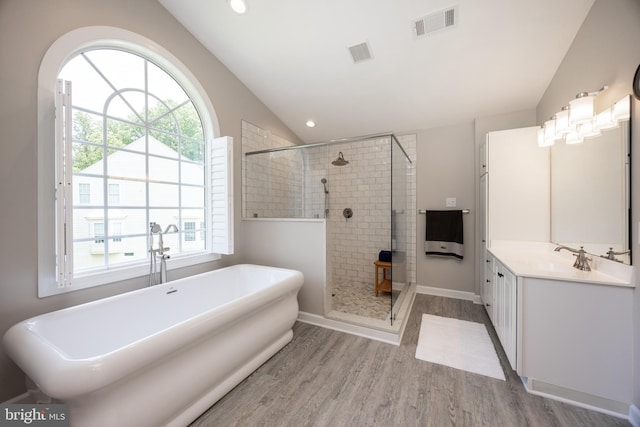 1568 Tattersall, West Chester, PA 19380 - bathroom with vaulted ceiling, wood finished floors, a stall shower, a freestanding tub, and healthy amount of natural light