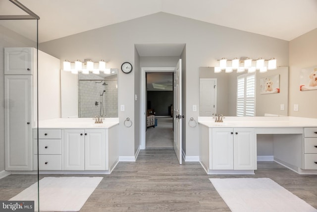 1568 Tattersall, West Chester, PA 19380 - full bathroom featuring lofted ceiling, tiled shower, wood finished floors, and two vanities