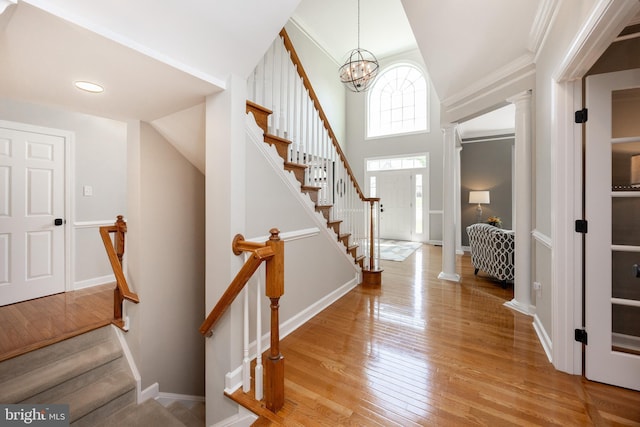 1568 Tattersall, West Chester, PA 19380 - foyer entrance featuring light wood-style flooring, stairs, a chandelier, ornamental molding, and ornate columns