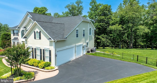 1568 Tattersall, West Chester, PA 19380 - view of side of property with a garage, a shingled roof, and driveway