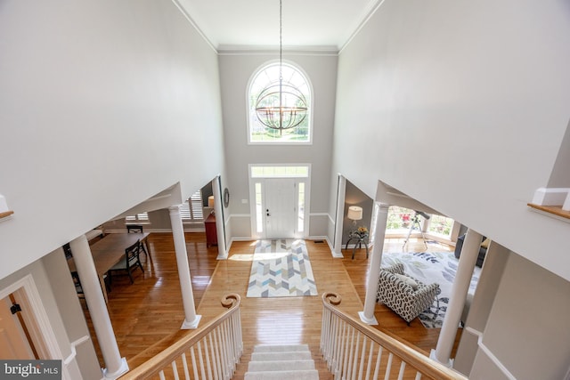 1568 Tattersall, West Chester, PA 19380 - entrance foyer featuring a chandelier, light wood-style flooring, crown molding, ornate columns, and a high ceiling